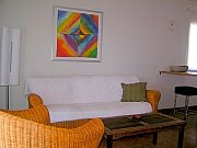 Casa Maria OG: Living room with wickerfurniture